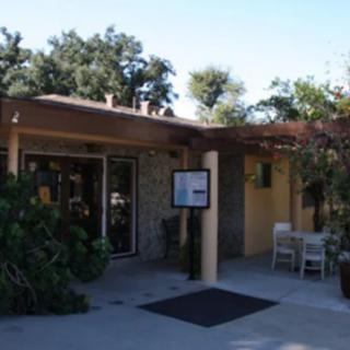 An outdoor view of a building entrance surrounded by trees.