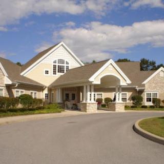 A large suburban house with a spacious driveway and a well-maintained entrance.