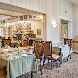 A cozy dining area with elegantly set tables and comfortable seating.