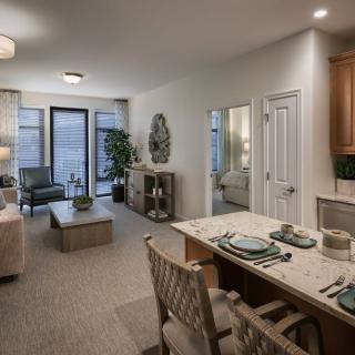 A modern open-plan living and dining area with stylish decor and neutral tones.