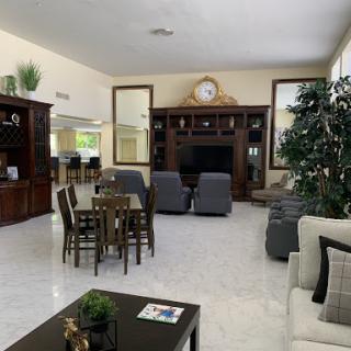 A spacious and elegantly designed living room featuring modern furniture and a cozy atmosphere.