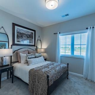 A cozy modern bedroom with elegant decor and ample natural light.