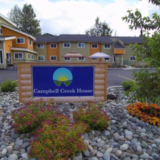 A welcoming entrance to a cozy inn, adorned with well-maintained landscaping.