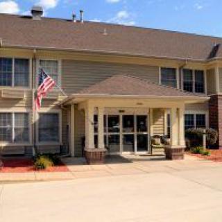 A suburban building with an American flag at the entrance.