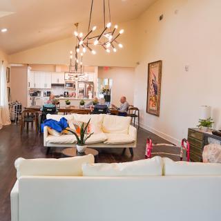 A stylish and modern open-concept living room featuring elegant furnishings and a bright atmosphere.