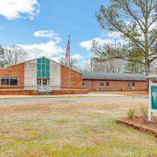 A community building featuring modern architecture, set against a clear blue sky.