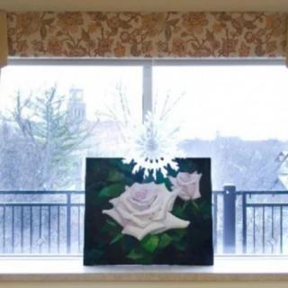 A painting of a white rose is displayed on a windowsill with a snowy backdrop.