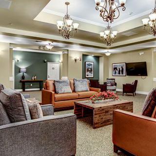 A spacious and elegant living room with comfortable sofas and stylish chandeliers.