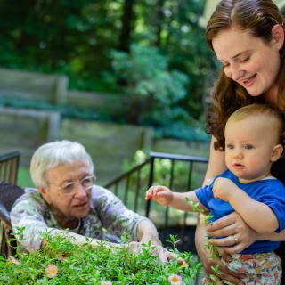 A multigenerational family enjoying time together in the garden.