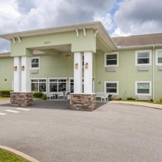 A modern hotel with a welcoming entrance and large columns.