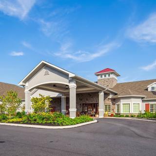 A well-maintained building with an inviting entrance and landscaped surroundings.
