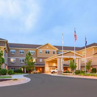 A hotel exterior with a welcoming entrance and flags displayed.