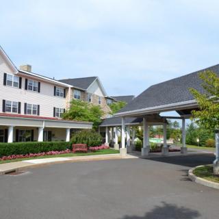 A large building with a covered entrance and well-maintained landscaping.