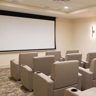 A cozy home theater with comfortable seating and a large movie screen.