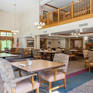 A spacious, well-lit dining area with a mezzanine and cozy seating arrangements.