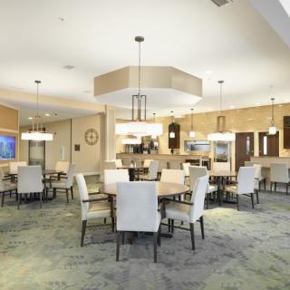 A modern dining area with elegant furnishings and lighting.