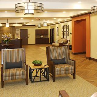 A modern lobby area featuring comfortable seating and stylish lighting.