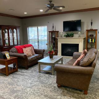A cozy living room featuring comfortable sofas, a coffee table, and a fireplace.