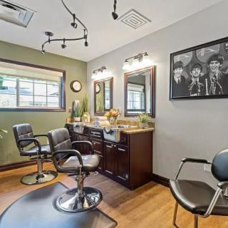 A cozy beauty salon interior with styling chairs and mirrors.