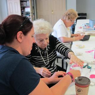 Women engaged in crafting activities at a community center.