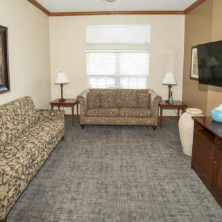 A cozy living room with two sofas, a television, and a coffee table.