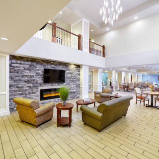 A spacious and modern lobby with comfortable seating and a fireplace.