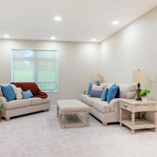 A cozy living room with sofas, decorative pillows, and a coffee table.