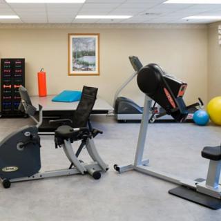 A fitness center equipped with exercise machines and therapy tools.