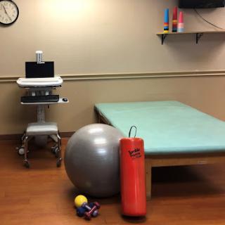 A physical therapy room equipped with various rehabilitation tools.