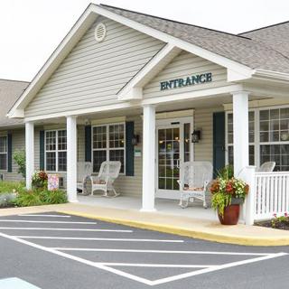 A building entrance with a porch and wheelchair-accessible parking.