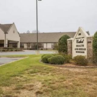 Exterior view of a healthcare facility with visible signage and surrounding landscaping.