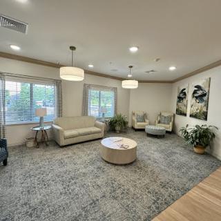 A modern and cozy lounge area featuring comfortable seating and natural light.