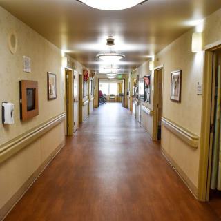 An empty hospital corridor with bright lighting and clean surroundings.