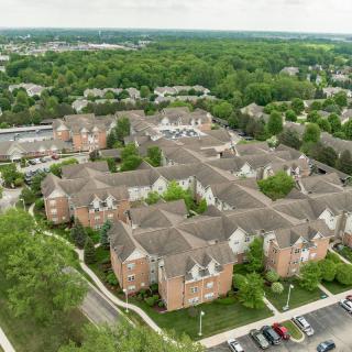 Aerial view of a suburban residential complex surrounded by trees.