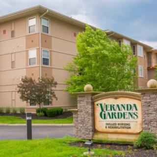 A view of Veranda Gardens apartment complex with well-maintained landscaping.