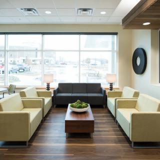 A modern and inviting waiting area with sleek furniture and ample natural light.