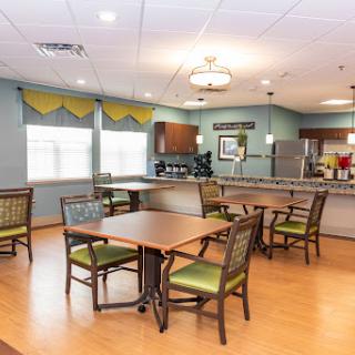 A warm and inviting dining area featuring modern furniture and a well-equipped kitchen.