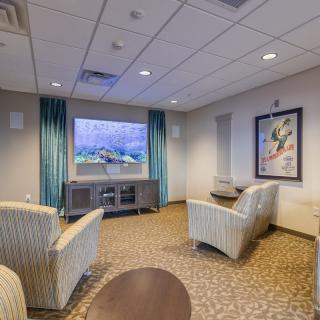 A cozy living room with comfortable seating and a large television.