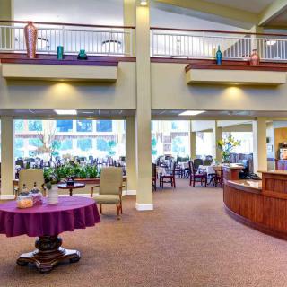 A spacious and modern lobby area with a reception desk and seating.