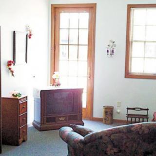 A cozy living room featuring a vintage television, comfortable sofa, and decorative elements.