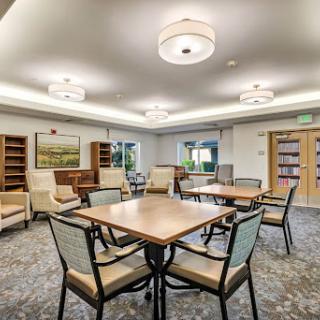 A cozy reading and gathering space featuring comfortable seating and ample lighting.