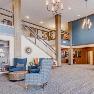 A spacious and elegantly designed lobby with comfortable seating and modern decor.
