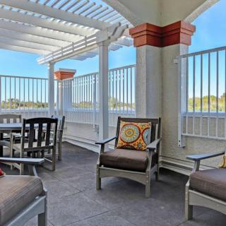 A stylish outdoor patio with comfortable seating and a pergola roof.