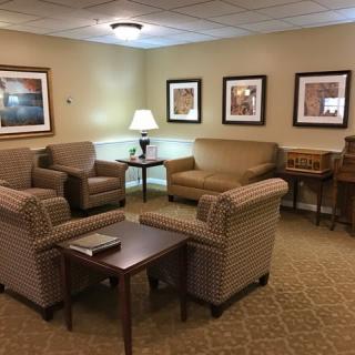 A cozy living room with comfortable seating, artwork on the walls, and a warm, inviting ambiance.