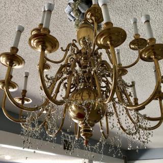 A beautifully ornate gold chandelier adorned with crystals, adding elegance to the room.