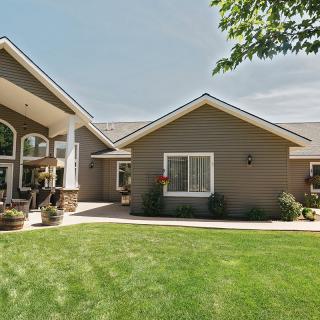 Exterior view of a suburban house with a well-maintained lawn.