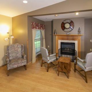 A cozy living room with a fireplace and comfortable seating area.