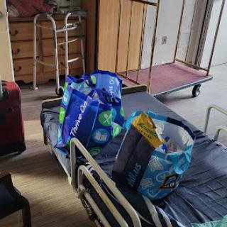 A glimpse of a hospital room featuring a bed with bags and medical equipment.