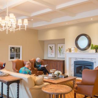 A cozy living room with comfortable seating, a fireplace, and elegant decor.