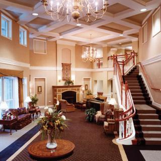 A luxurious hotel lobby featuring a grand staircase and elegant decor.